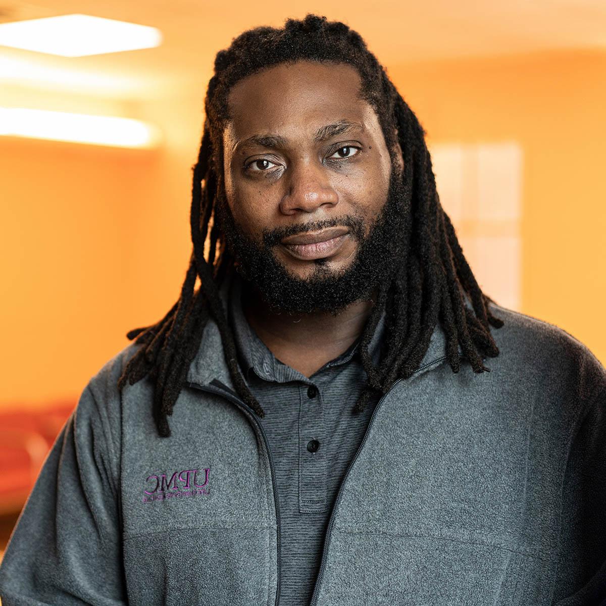 Portrait of Chatham alumnus James Russell at work at UPMC.