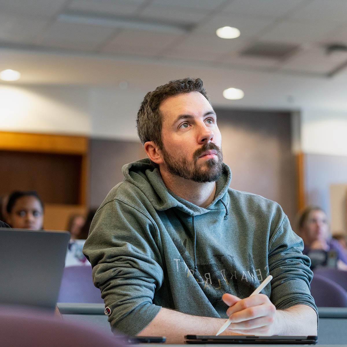 Students diligently pay attention and take notes in a lecture hall